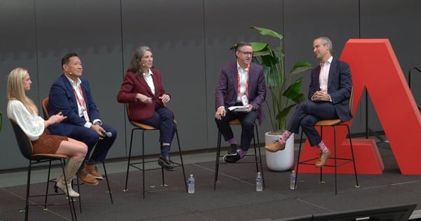 Five panelists sitting on tall stools with the A of the Adobe logo showing at far right.